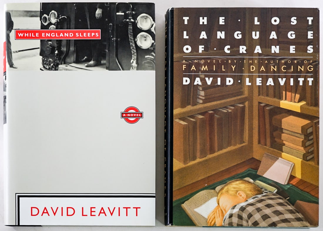 David Leavitt (2) SIGNED w/ Inscription Books: 1) While England Sleeps. Viking 1993 1st with unclipped dust jacket. 2) The Lost Language of Cranes. Alfred A. Knopf 1986 1st with unclipped dust jacket. Lot measures 9 in. H x 6 in. W x 2.5 in. D for