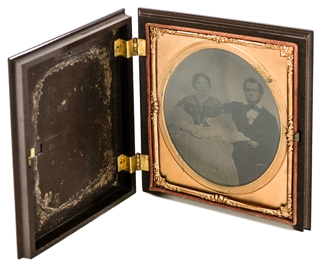Antique Ambrotype Photo w/ Percha Case 1/4 Plate: Antique Ambrotype 1/4 plate photo of couple with Gutta Percha frame. Measures with frame 5 x 4 x .75 in. Lot measures 5 x 4 x 1 inches for shipping purposes. The absence of a condition report does not
