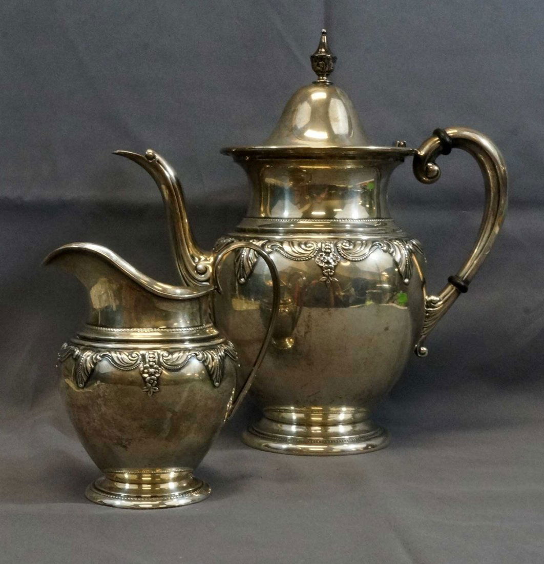 Wallace Sterling Stradivari Teapot and Creamer: Weighing 926 grams total, teapot measures 10" x 9 3/4", creamer measures 5" x 4". Both are in excellent condition.