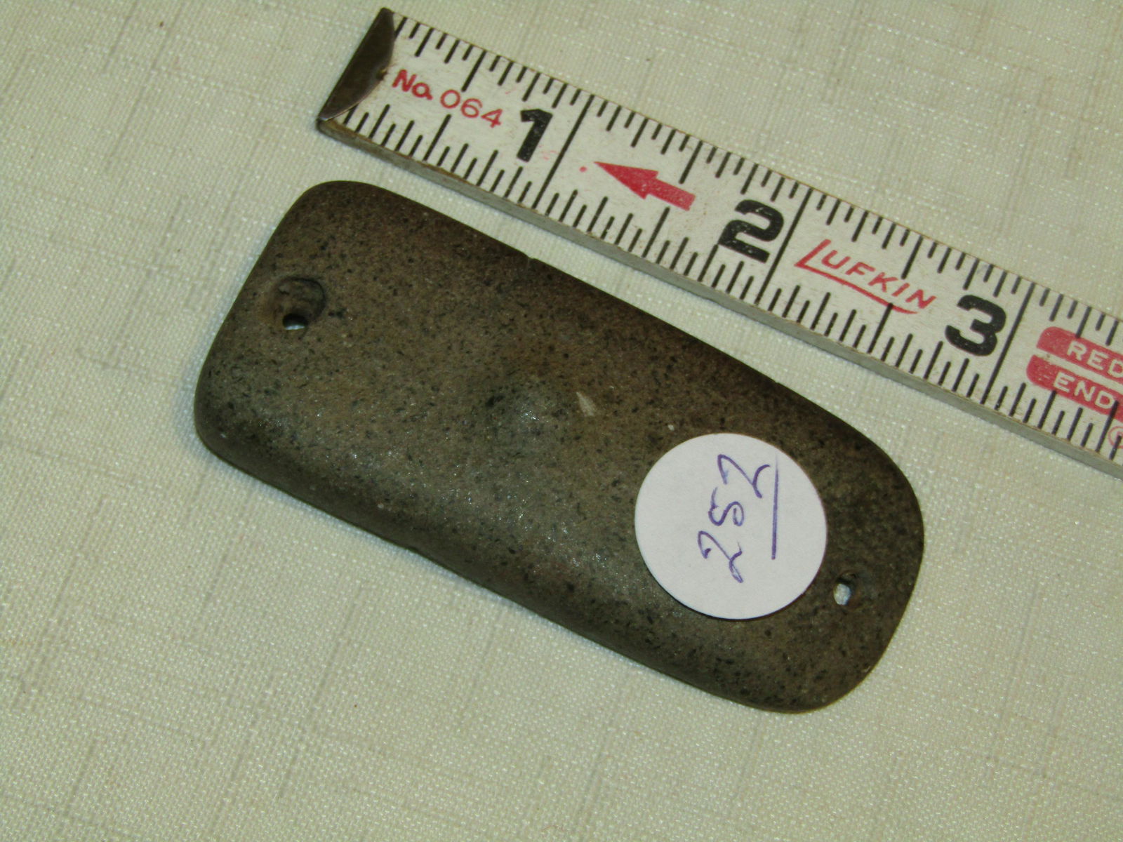 Gorget: 3" knob backed 2-hole gorget in the shape of a celt, Iowa