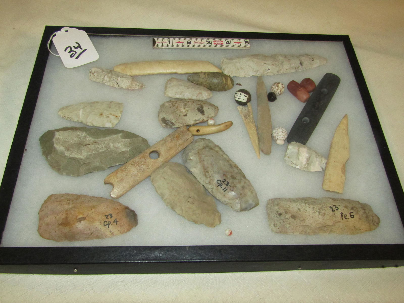 26 [c misc: Riker with 26 various tools, flint, pendant, gorget etc