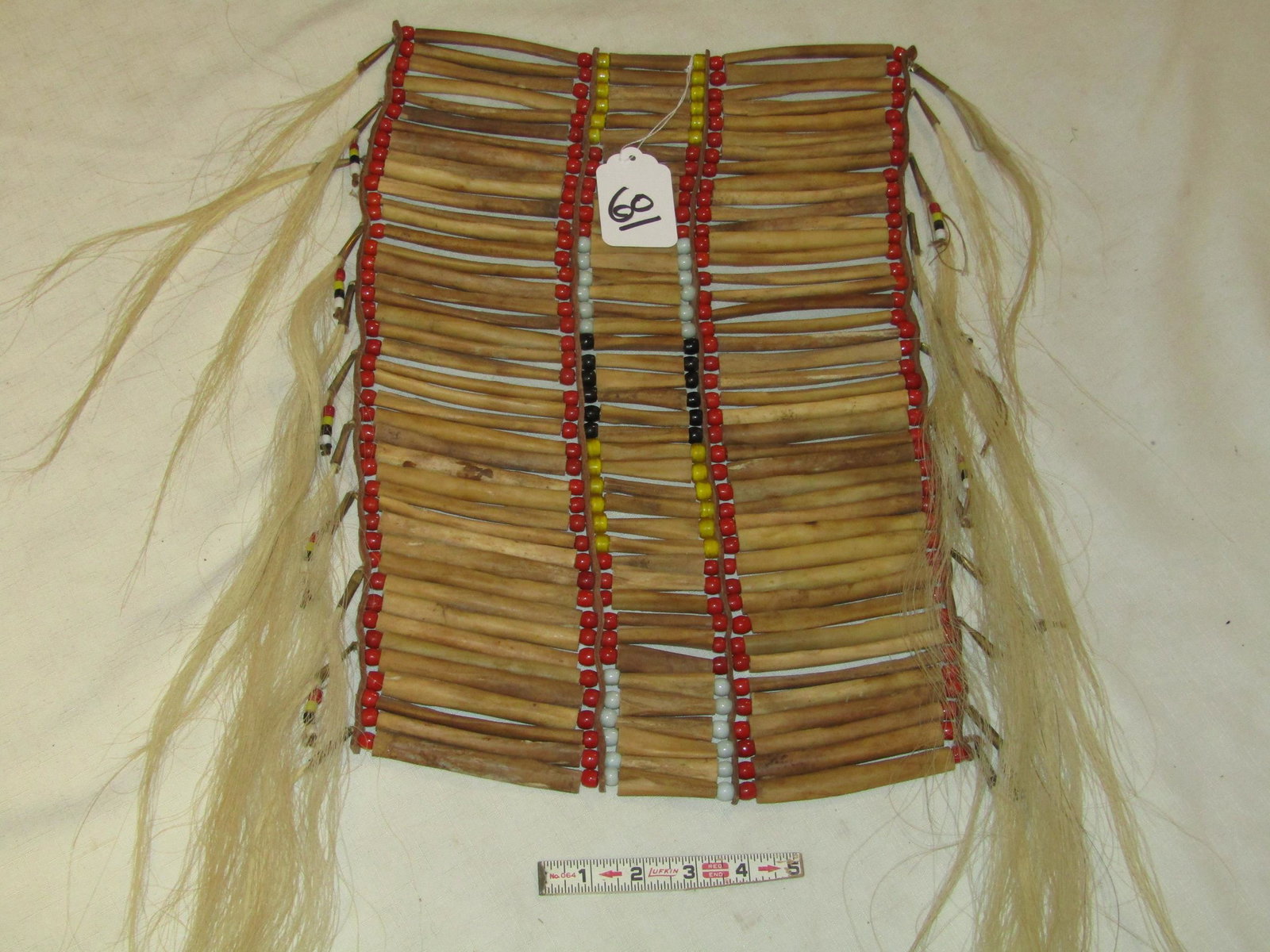 Breast plate: Plains adult bone breast plate, cones, sinew sewn,trade beads, horse hair, Good cond. Ca. Early 20th century
