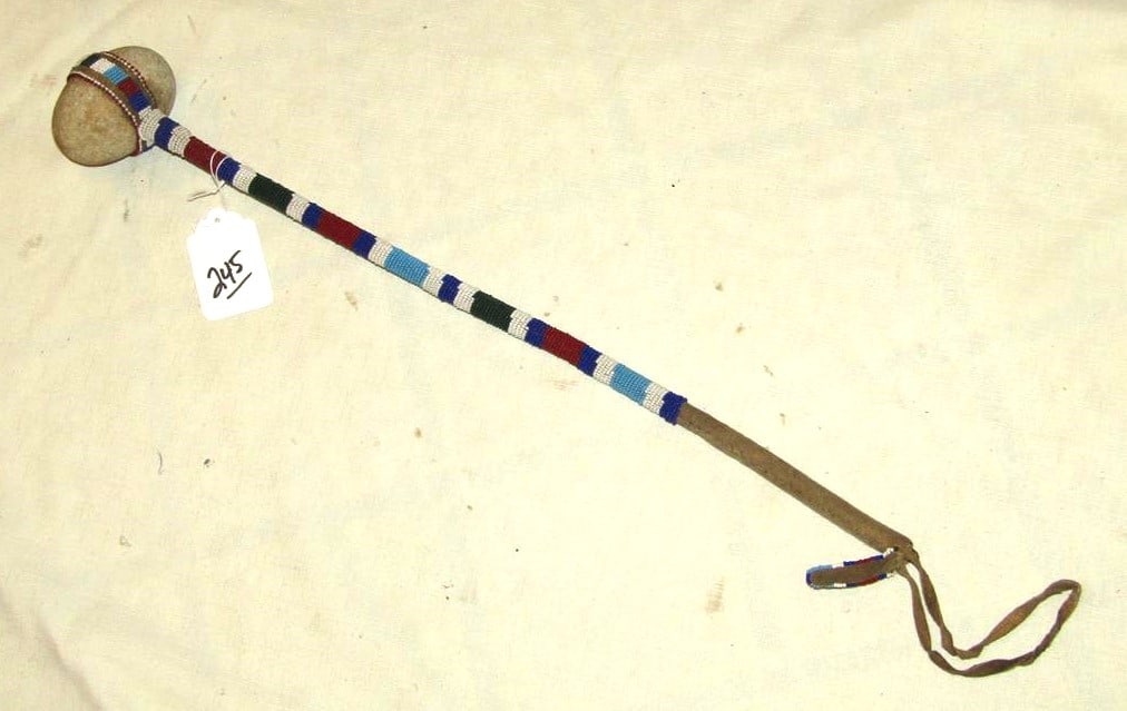 Club: Plains 22 1/2" 3 1/4" stone headed club, bead handle, sinew, good cond.. Ca.1910