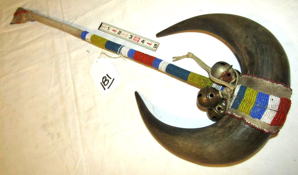 Rattle: Plains Buffalo horn rattle, 20", bells, sinew sewn, very good cond early 20th
