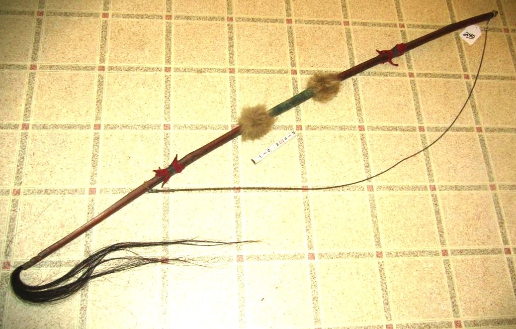 Bow: 53" wood bow with sinew string, fur and trade cloth wraps, sinew hide center,