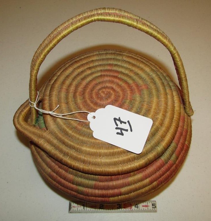 Basket,: Eskimo 9" coiled basket with handle, faded polychome, good cond