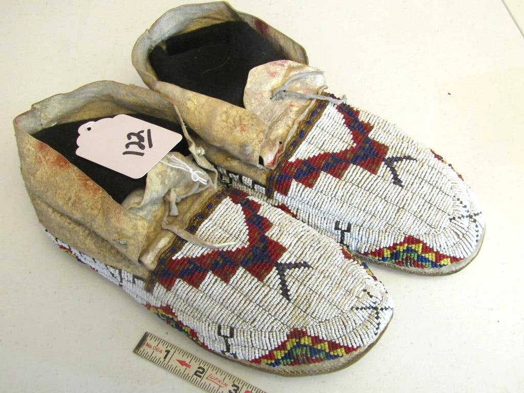 Moccasins: Sioux 10 1/2" full beaded moccasinsm, traces of red ochre, sinew sewn, good/very good condition