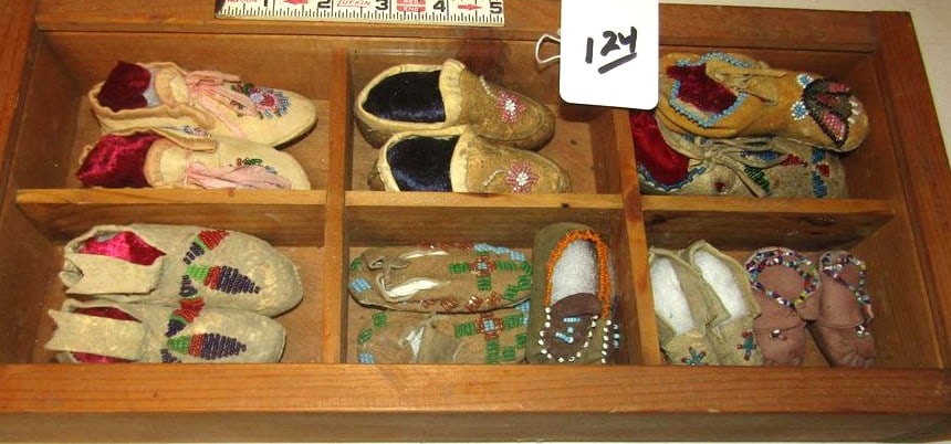 Moccasins: Wood display with 7 pr bead baby moccasins and 2 single beaded moccasins, good cond