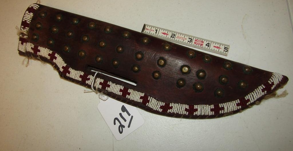 Knife case: Plains 14 1/2" tack decorated harness leather knife case, some sinew repair, some loose beadwork, good cond