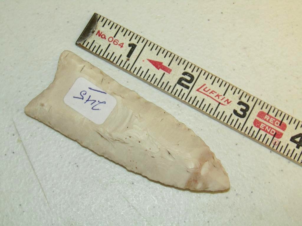 Point: 3 7/8" fluted Clovis point, not examined for coa