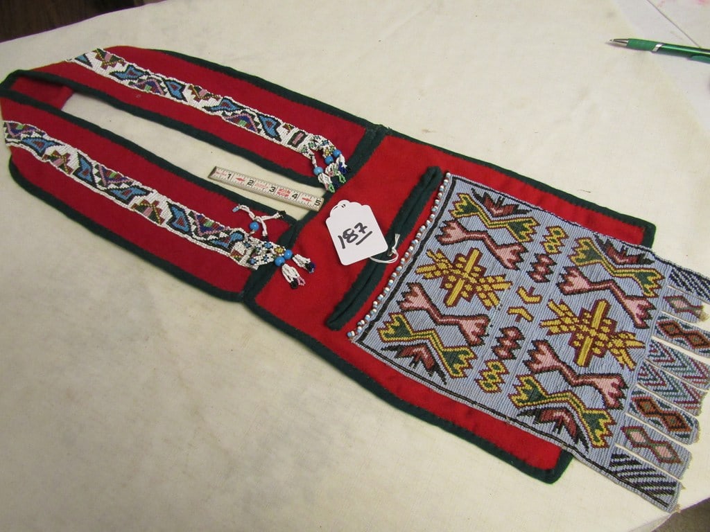 Bandolier: Great Lakes child's beaded bandolier bag, 30" x 10", minor tab loss, tiny and pony beads, red stroud cloth, good condition,