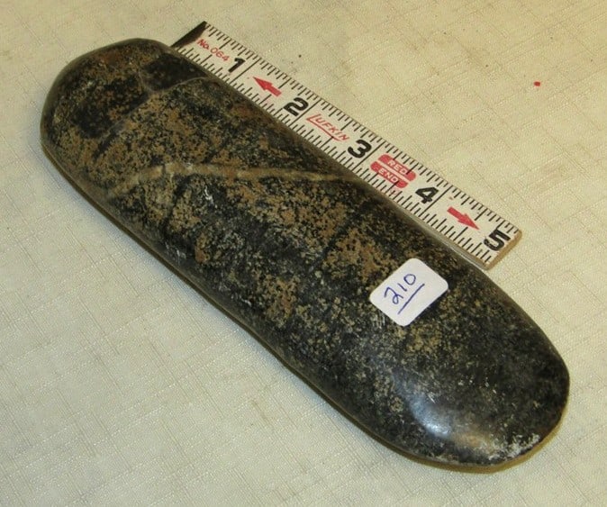 Celt: 7" polished celt, not examined for coa