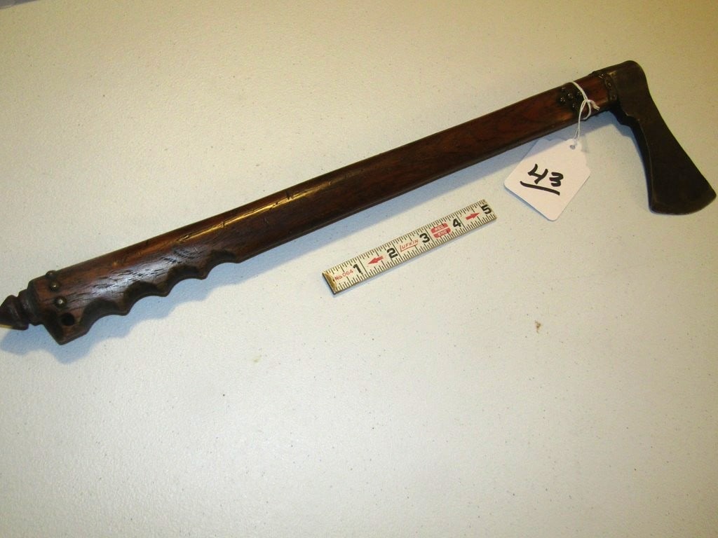 War club: Plains 18 1/2" wood stemmed and notched handle war club with 5" metal axe head, tack decorated, good condition,