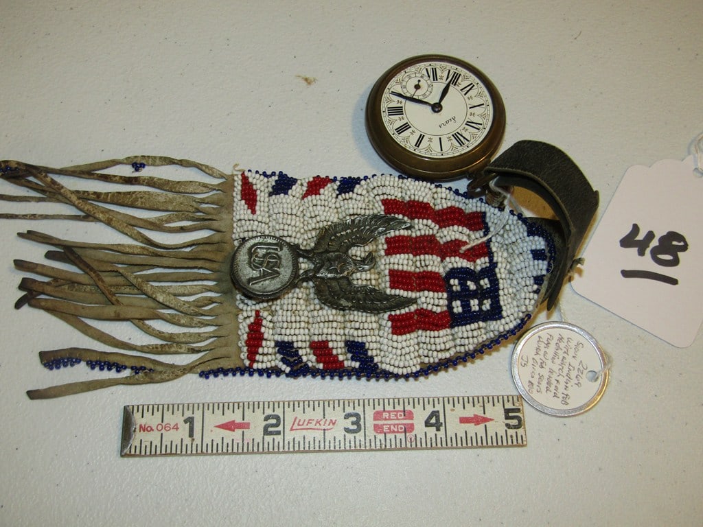 Pocket watch: Small display with pocket watch abd beaded sinew sewn pouch, flag decorated, with information tag, good condition