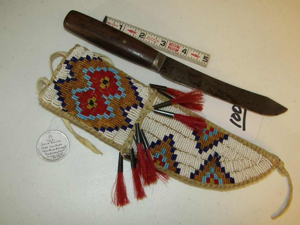 Knife case: Sioux fully beaded 9 1/4" knife case with knife, cones, horse hair, information tag, sinew sewn, very good condition
