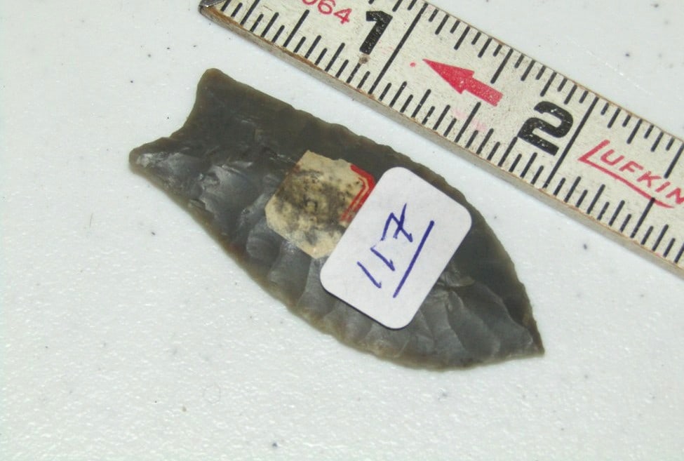 Point: 2 1/4" gray Quad point with hard to read info, Lamp collection, not examined for coa