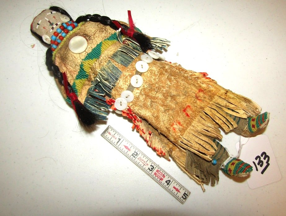 Doll: Plains 12" hide doll, beadwork, shell decorated, sinew sewn, human hair, with stand, good condition, Beranek collection