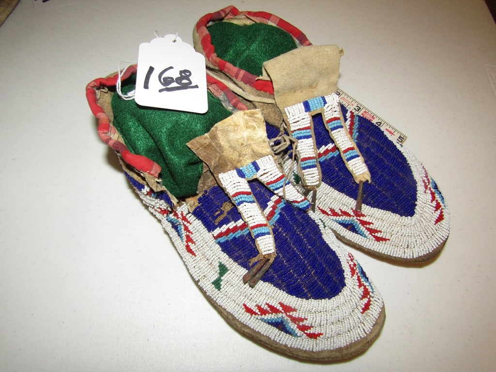 Moccasins: Sioux 10 1/2" full beaded moccasins, small torn area by tabbed tongue, sinew sewn, top is somewhat stiff top, basically good condition, Beranek collection