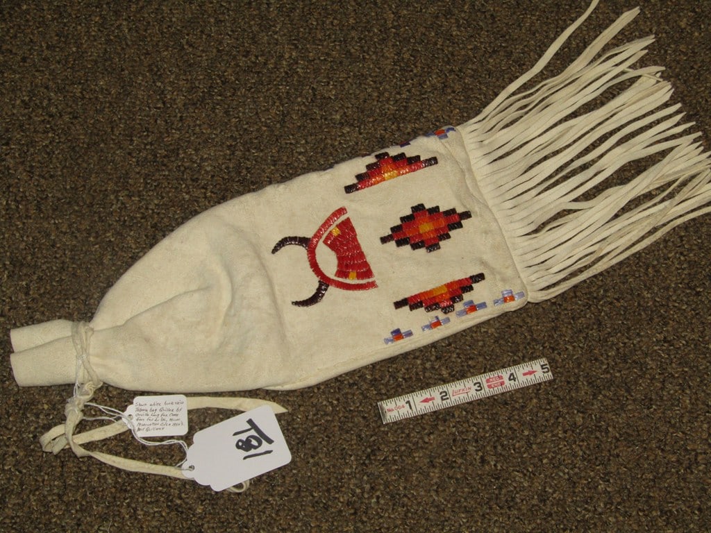 Tobacco bag: Sioux white buckskin quilled tobacco bag, 21" including fringe, with tag information