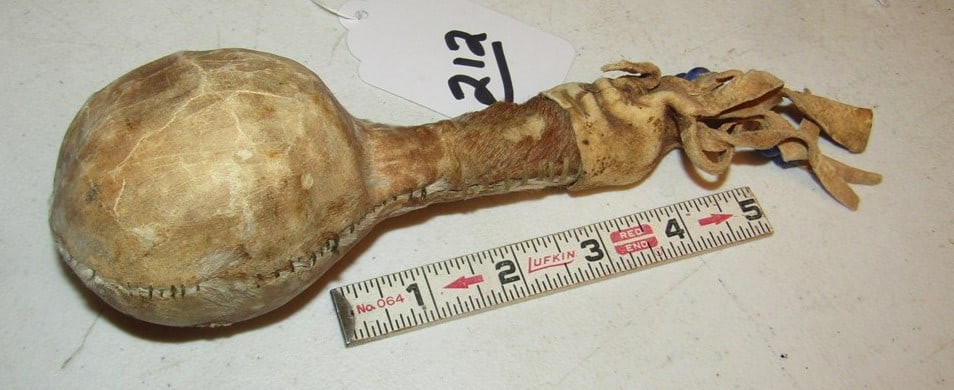 Rattle: Southern Pkains 7" hide rattle, broken hide on rattle covering, sinew sewn, Beranek collection, Fair condition