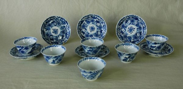 A Set of 6 Blue & White Tea Cups & Under Plates. D: A Set of 6 Blue & White Tea Cups & Under Plates. Decorated with alternate village scenes and floral scrolls. Underglaze blue floral mark to bases. Kangxi period. Several small chips & hairlines. Cup D
