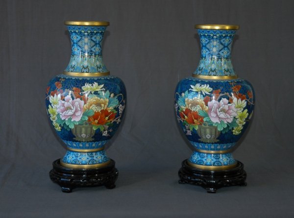 Pair Chinese Cloisonne Vases. Zou Qi Lei Design m: Pair Chinese Cloisonne Vases. Zou Qi Lei Design made by Beijing Enamel Plant. Peony & blossoms, on blue patterned ground. Each vase on black plinth. Sales brochure available. H 31.5cm