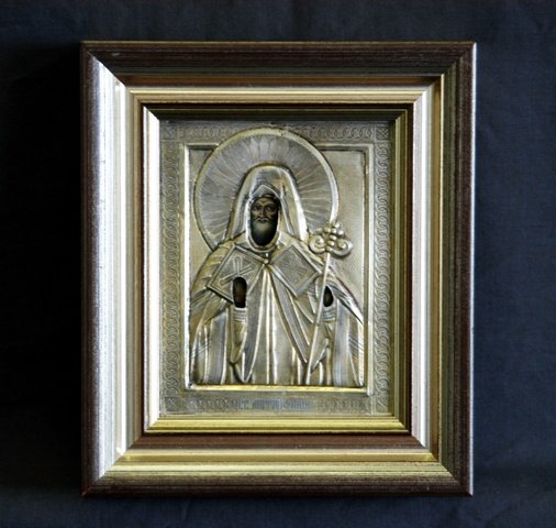 19th C Russian Icon. St Mitrofany. Obverse wood : 19th C Russian Icon. St Mitrofany. Obverse wood panel cracked. Has extensive text to obverse, cyrillic inscription. 12x10cm Gilded Silver & Tempera on Panel