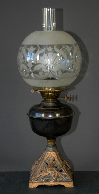 Edwardian Cast Iron Kero Lamp. Pierced pyramid ba: Edwardian Cast Iron Kero Lamp. Pierced pyramid base, steel front with duplex burner. Chimney & acid etched diffuser. H 59.5cm