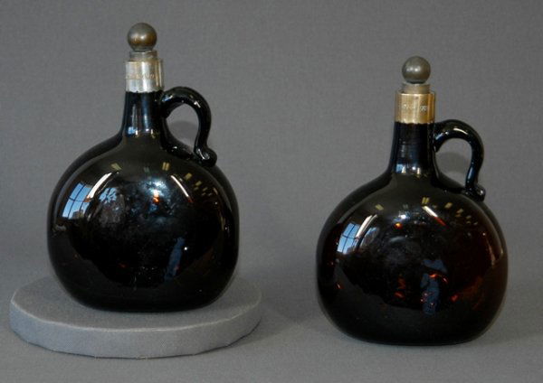 Pair Mid Victorian Moulded Brown Glass Flasks. Or: Pair Mid Victorian Moulded Brown Glass Flasks. Original cork stoppers. Engraved collars & initials & date 1869. H 19cm