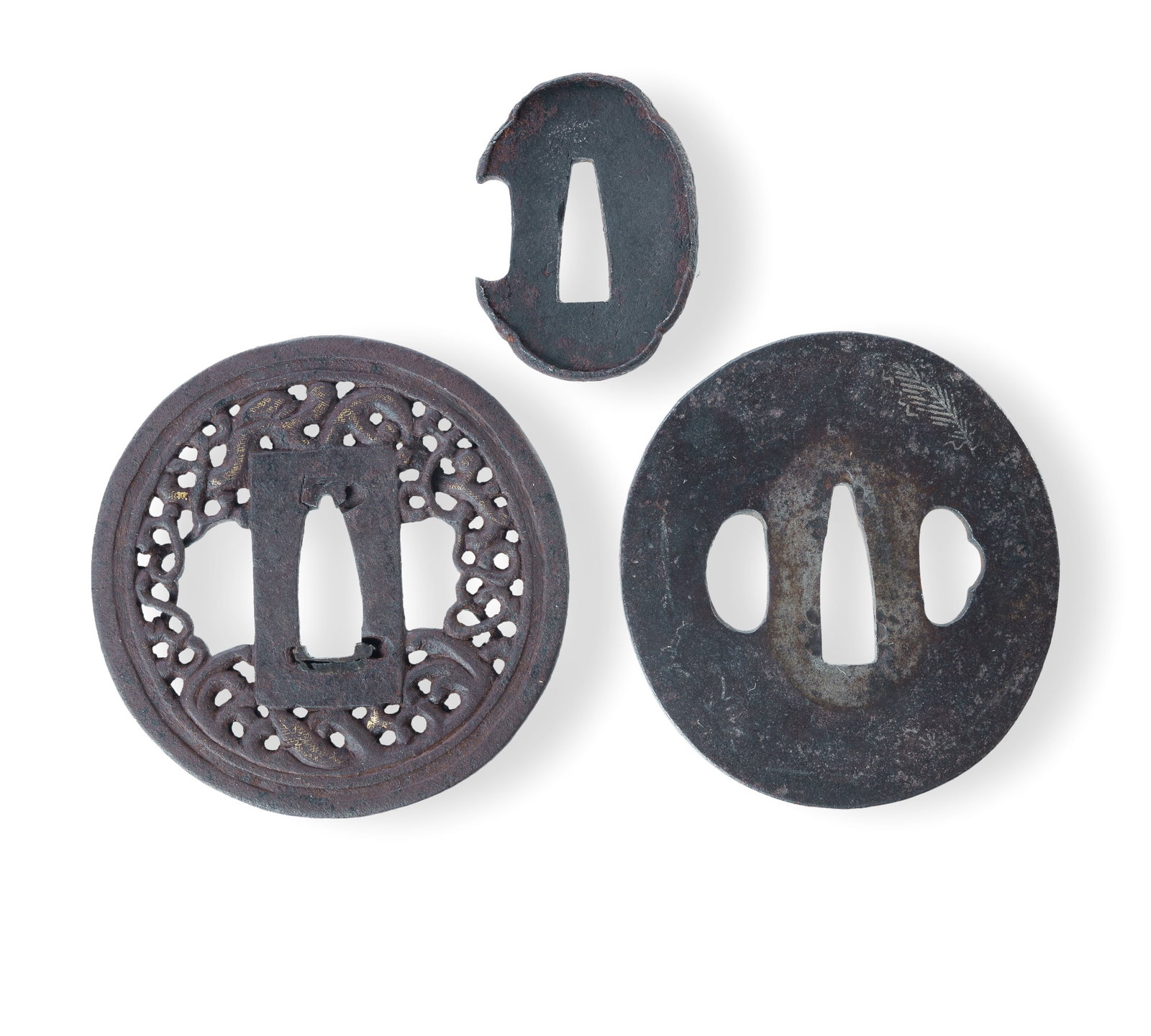Three Japanese Iron Tsuba: Three Japanese Iron Tsuba An early Edo period 'Namban' tsuba featuring a pierced design of writhing dragons, with remnants of the original gold inlay (dia.7 cm, thickness 0.4 cm); an unusual oval tsub