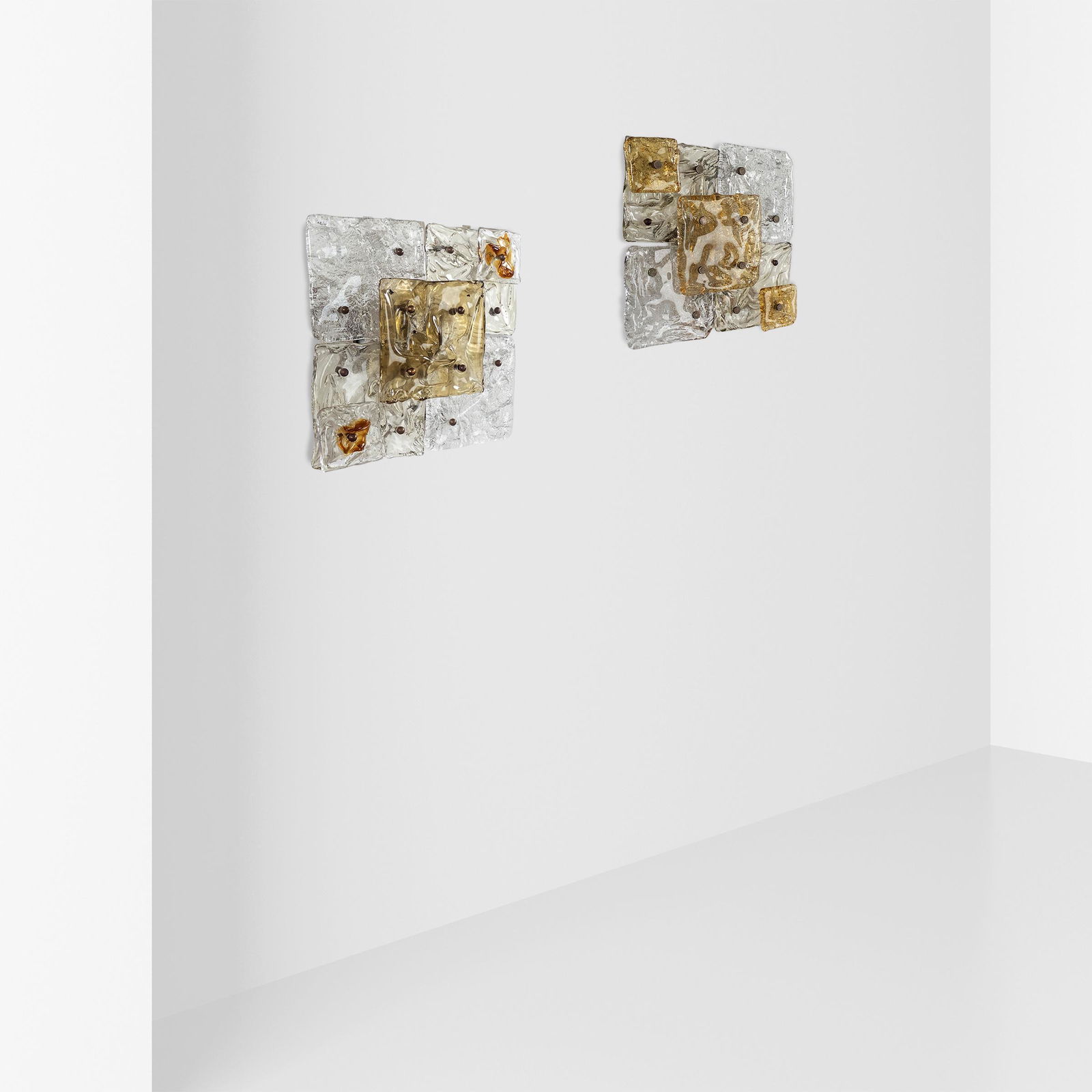 Toni Zuccheri, prod. Venini (2): Murano, 1968 circa 30x30x10 cm., two Patchwork series wall lamps, transparent and amber glass diffusers, lacquered metal and brassLiterature: Franco Deboni, I vetri Catalogo 1921-2007, Torino 2007, ri