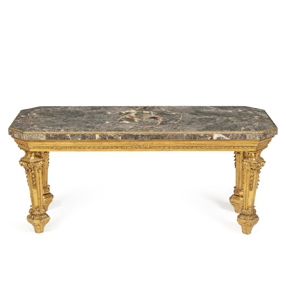 Gilded wood coffee table: Rome, 18th century, 52x120x50,5 cm., made with coeval legs, mounted on an octagonal structure of the 20th century, top in African marble with border in chiseled gilt bronze