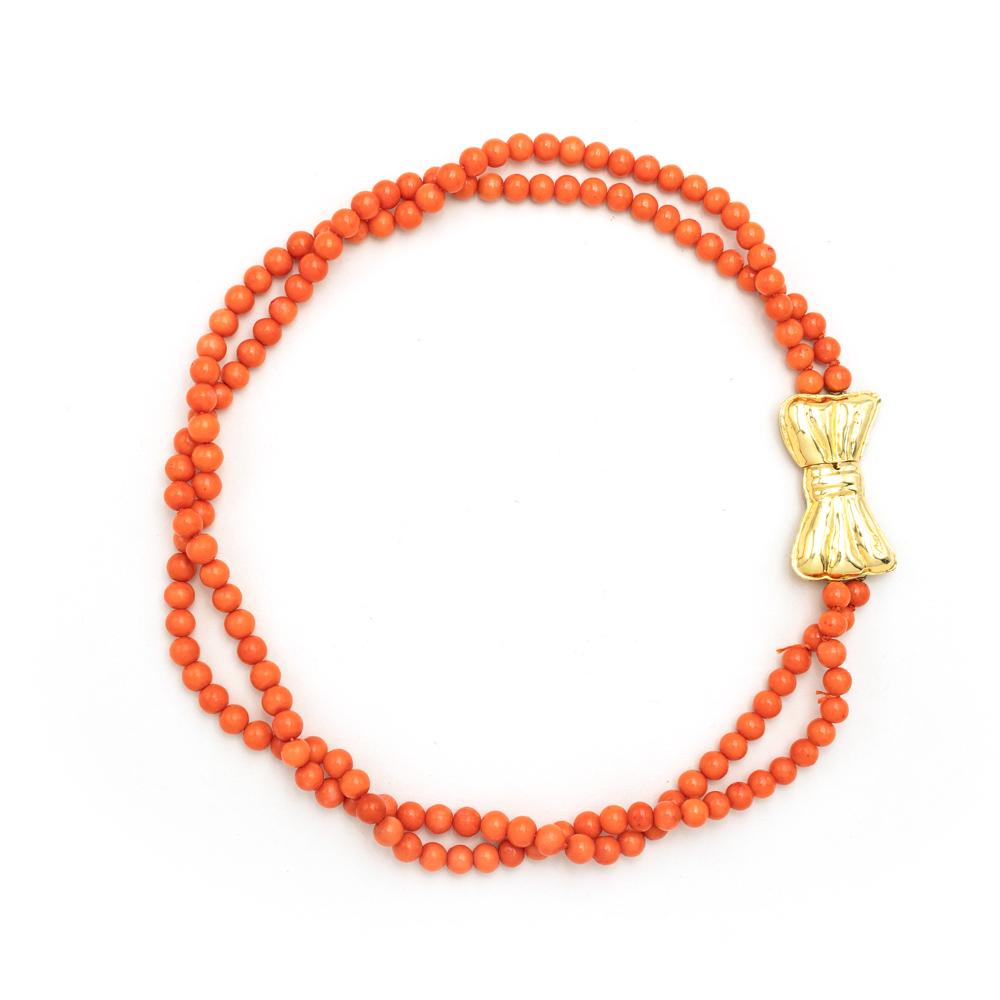 Two strands of Mediterranean coral necklace: , weight 70 g., spheres 7mm. joined by a bow closure in 18kt yellow gold, length 48 cm.
