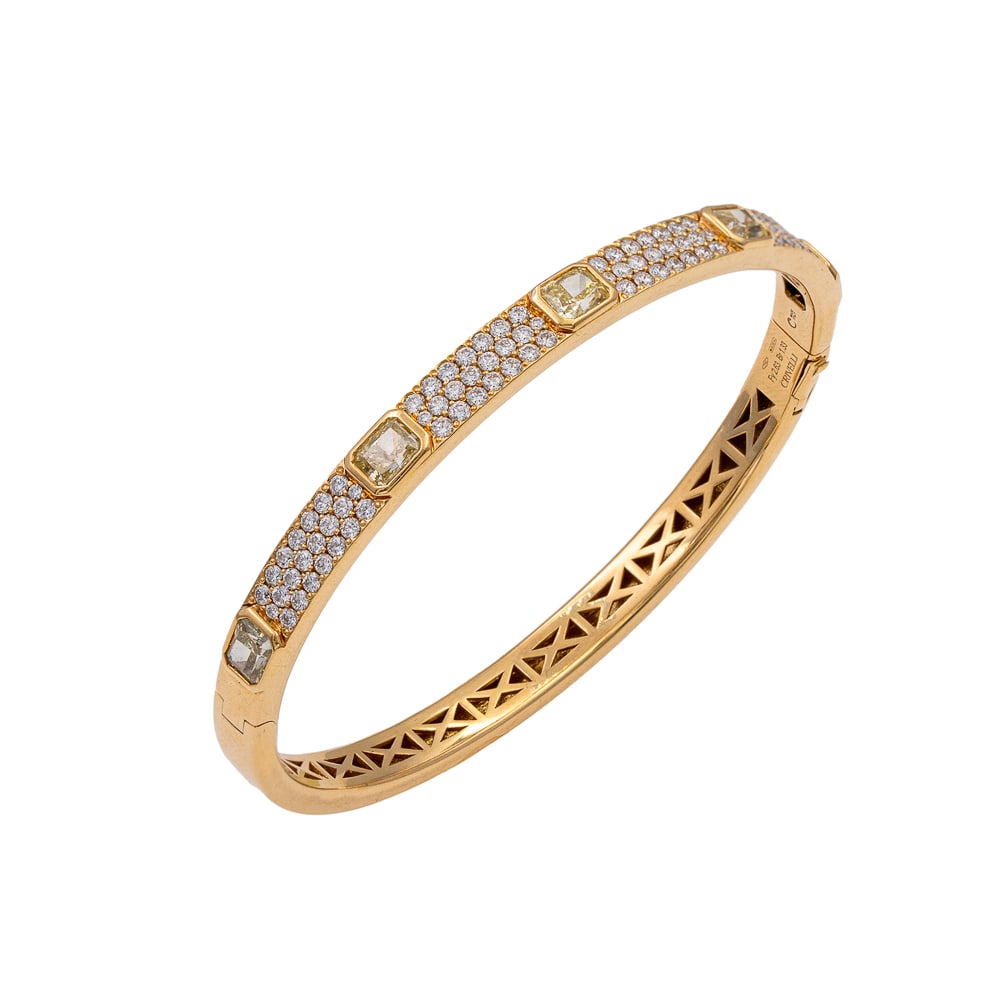 Crivelli cuff bracelet: signed, weight 18 g., in 18kt yellow gold, five fancy yellow emerald-cut diamonds circa 2.63 ct and brilliant-cut diamonds circa 1.33 ct, snap clasp, diameter 6 cm.