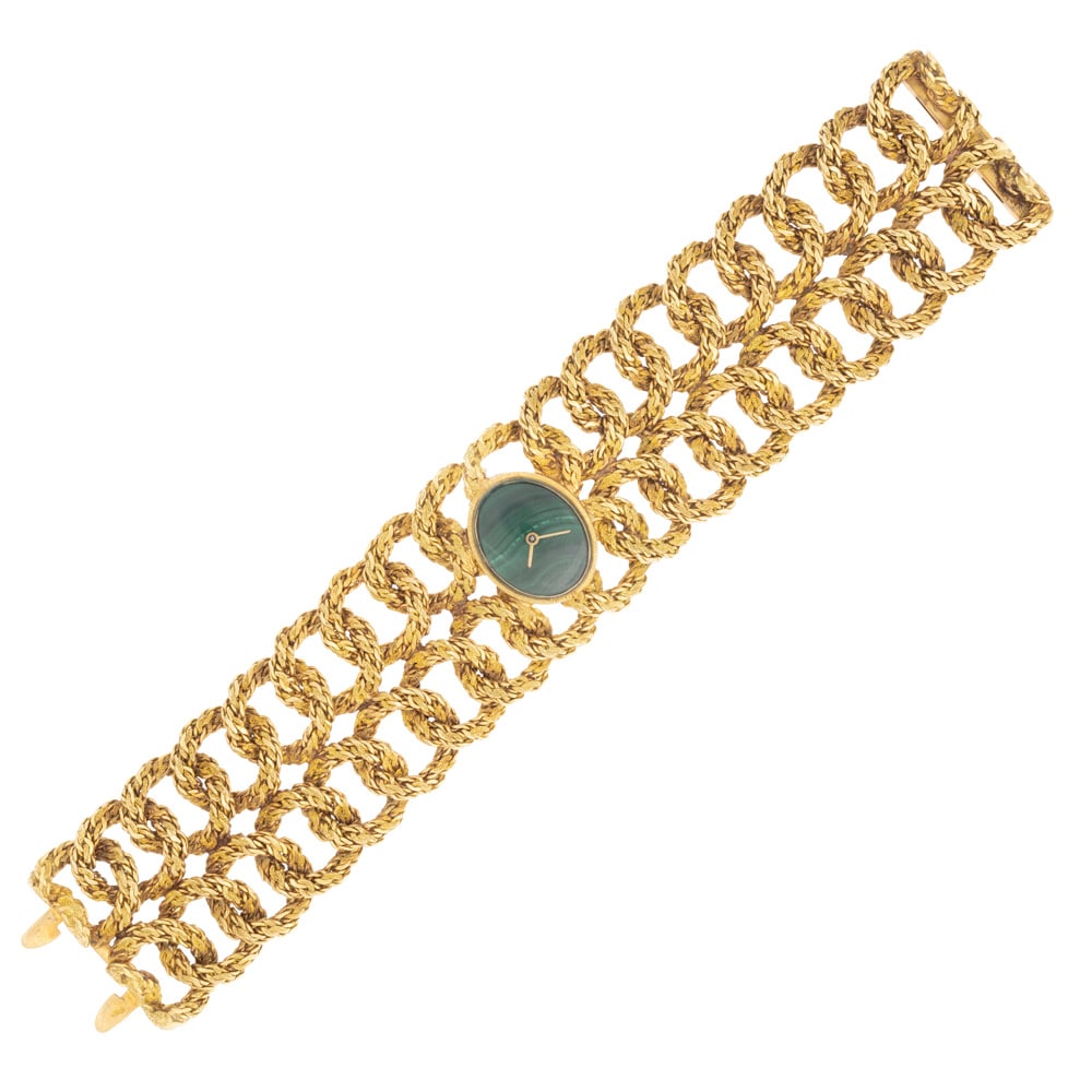 18kt yellow gold ladies watch bracelet: circa 1970s, French marks, weight 125 gr., oval case 21x17 mm. malachite dial without indexes, mechanical movement with manual winding, links bracelet with concealed clasp, length 18 cm. - height 3.3