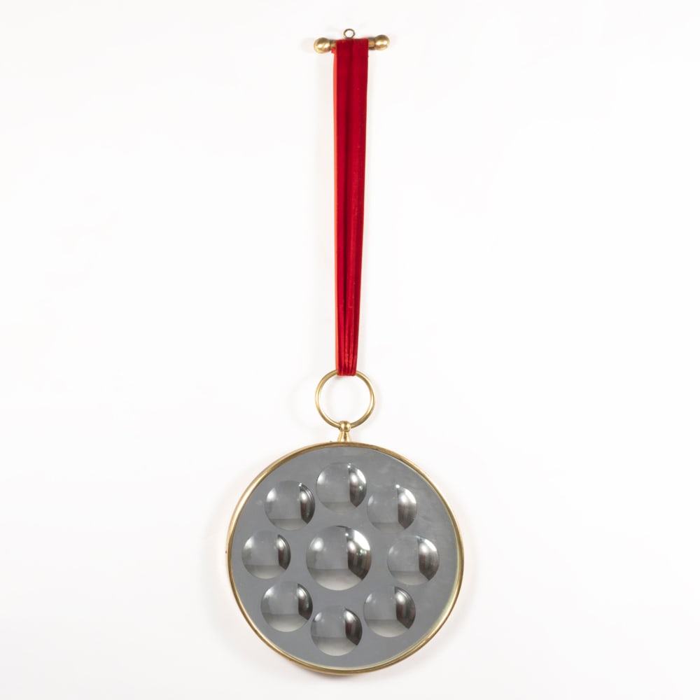 Piero Fornasetti (Milano 1913 - 1988): Prod. Fornasetti, Italy, 1950/60s, 84x30 cm., Specchio Magico mod. wall mirror in brass, fabric and mirrored glass, production label, slight wears