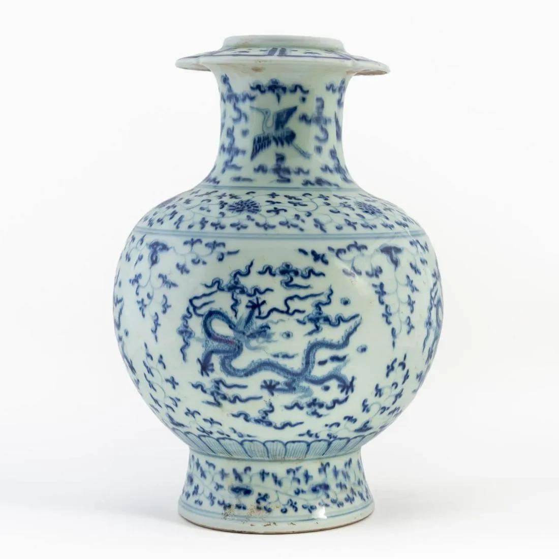Chinese blue and white porcelain dragon vase: Chinese blue and white porcelain dragon vase, of globular form, having a discoid rim with a lappet band above a waisted neck decorated with flying cranes, surmounting a globular body embellished with 