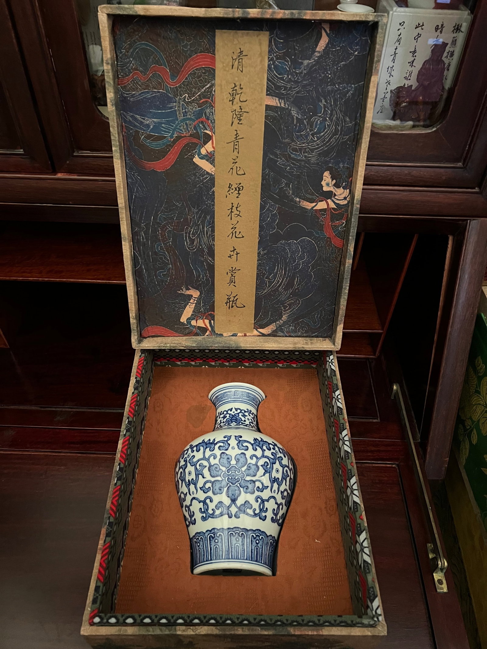Chinese Blue and White Floral Vase Qianlong Seal Mark, Qing Dynasty Style: A finely potted Chinese blue and white porcelain vase of baluster form with a slightly flared neck, decorated in underglaze cobalt blue with elaborate scrolling floral and foliate motifs. The body is 