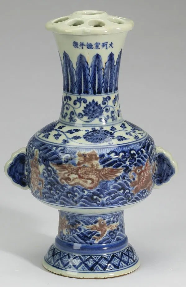 Chinese Ming style blue and iron-red peacock feather vase: having a pierced lid (meant to hold feathers) and flora form rim above a trumpet neck with plantain and peony scroll bands, the body decorated with iron-red mythical creatures including dragons, qilin