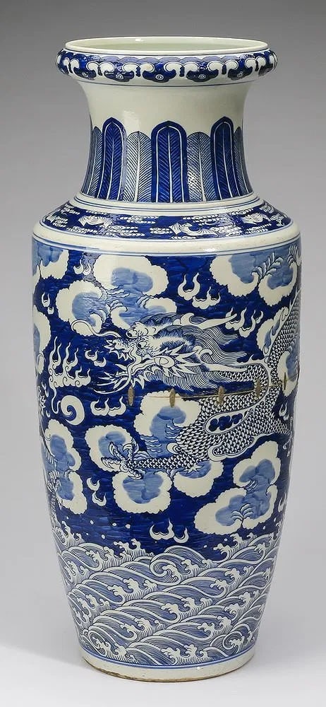 Chinese blue and white rouleau vase: having a ruyi band at the dished rim above a slightly waisted neck with a plantain band, the tapering body decorated with writhing five clawed dragons contesting a flaming pearl of wisdom amidst auspi