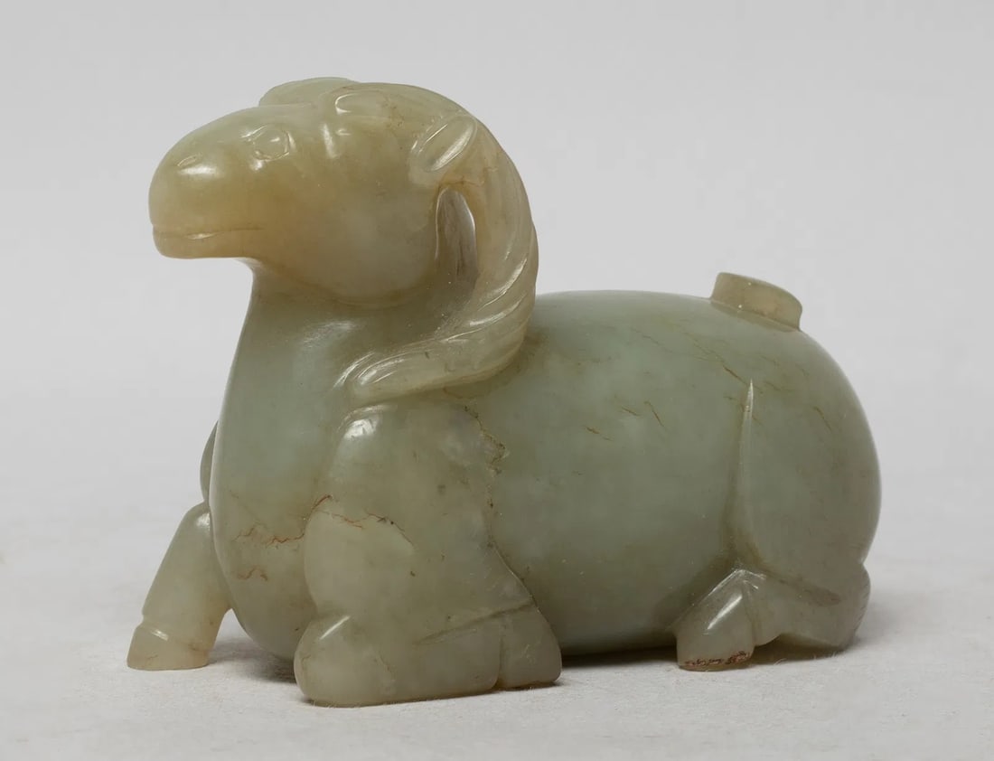 Chinese Antique Celadon Jade Carved Recumbent Ram Water Dropper or Scholar's Vessel, Qing Dynasty St: The recumbent ram with its right front leg stepping out and other legs bent, its head looking forward, finely incised with almond-shaped eyes, nose and mouth, the stone of pale celadon tone. Approx. 3