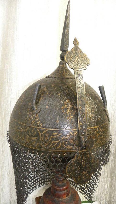 RARE PERSIAN WARRIOR HELMET ARABIC INSCRIPTION: Rare Persian warrior helmet, bottom rim Arabic inscription skull surface floral Chiseled engraving. Province : Persian. Made : Made of heavy t iron sheet , hand hammered and hand chiseled. Dating : un