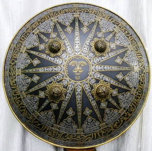 STUNNING INDO PERSAIN MILITARY WARRIOR SHIELD SUN FIG.&VINE BANDS CALLIGRAPHY: INDO PERSIAN ISLAMIC SHIELD ARABIC INSCRIPTION SUN FIG ENGRAVED VINE BANDS FLORAL. Dated : Unknown .Made : Made of hand forged steel hand hammered and hand chiseled. Measures : 19 inches in diameter.