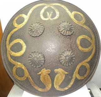 ARMOUR A COLLECTOR CHOICE PERSIAN WAERIOR SHIELD LIVE SIZE MALE & FEMALE SNAKE FIGS ENGRAVED: A rare finding of Persian warrior shield. With 2 live size snakes engraved. Province : Indo Persian. Surface : 2 live size snake , male & female engraved. MADE : Hand forged steel , hand hammered & ha