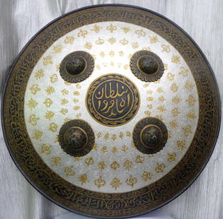 ARMOUR MUGHAL /ISLAMIC WARRIOR SHIELD ARABIC INSCRIPTION SKULL FLOWERAL MOTIFS: .Shape : Taper, convex form. Made : Made of hand forged steel , hand hammered and hand chiseled. Surface: The shield bears an elaborate chiseled engraving over its entire surface With floral and creep