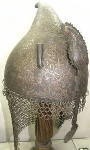 ARMOUR MUGAL WARRIOR HELMET ARABIC INSCRIPTION SKULL RIM ARABIC INSCRIPTION CHISELED LAVISH FLOWER: Province: Mughal. Made : Made of heavy iron sheet , hand hammered and hand chisel. Skull : Has chiseled engraving medallions comprising of Arabic calligraphy. Helmet bears an elaborate chiseled engrav
