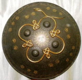 ARMOR MUSEUM LEVEL PERSIAN WARRIOR SHIELD SNAKE & SUN FIGURE SURFACE CHISELED FLORAL: ARMOR MUSEUM LEVEL PERSIAN WARRIOR SHIELD SNAKE & SUN FIGURE SURFACE CHISELED FLORALProvince: Persian. . Made: Made of hand forged steel, hand hammered and hand chiseled. Central panel has Sun figure