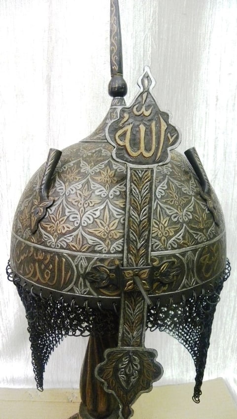 HELMET INCREDIBLE SKULL MEDALLIONS FLOWER MOTIFS ARABIC INSCRIPTION NASAL GUARD: Helmet incredible Entire surface carved with medallions carved flower motifs. Made of hand forged steel hand hammered and chisel. Bottom rim and nasal guard has Arabic calligraphy FROM HOLY book Koran