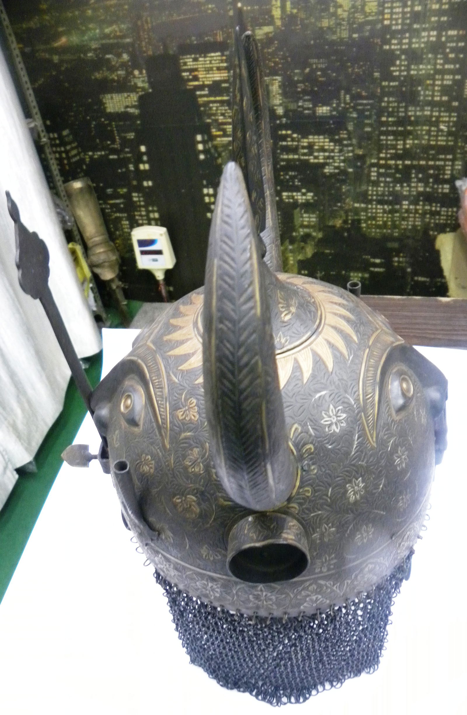 INCREDIBLE HELMET OLD ( KULAH KHUD ) 2 DEMON DEVILS FACES FRONT & BACK , 2 HORNS, MUSTACH: A finely crafted Indo-Persian steel helmet featuring a rounded dome adorned with intricate floral and sunburst engravings enhanced with gold koftgari work. The prominent central spike rises boldly fro