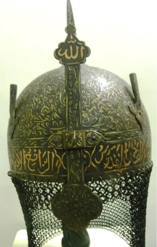 GEM OF COLLECTION PERSIAN HELMET ARABIC INSCRIPTION BOTTOM RIM SKULLFLORAL & TENDRIL NASAL GUARD: Incredible helmet. Bottom rim Arabic inscription to invoke Gods power and blessing. Nasal guard God ALLAH name engraved. Province: Indo Persian. Skull: Hand engraved chiseled incredible floral design